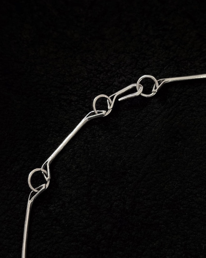 Close-up of handcrafted 925 sterling silver bracelet with jawbone-inspired sculptural form